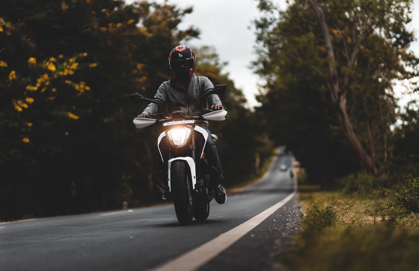 Helmeted motorcycle rider on an Indian road